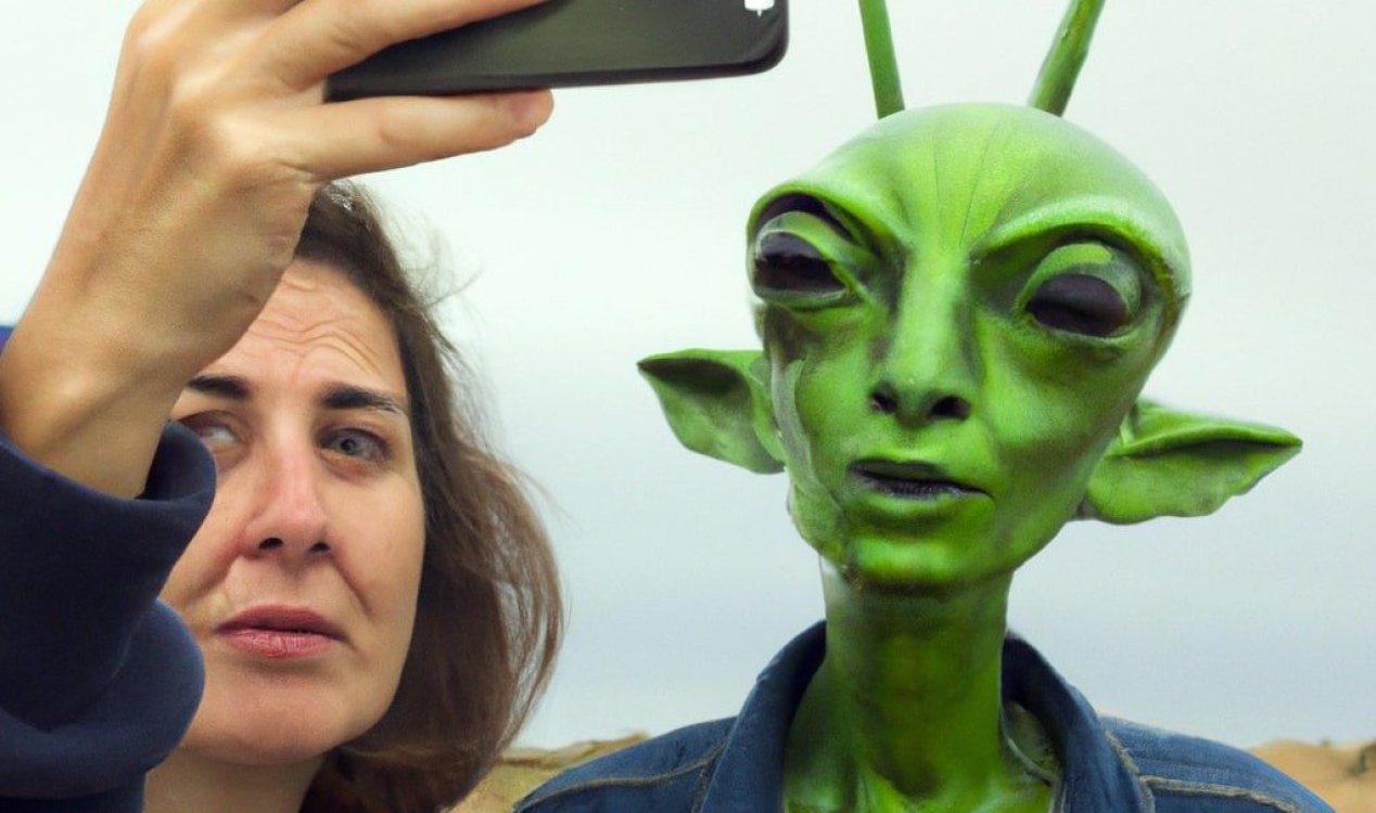 Woman taking a selfie with a green alien.