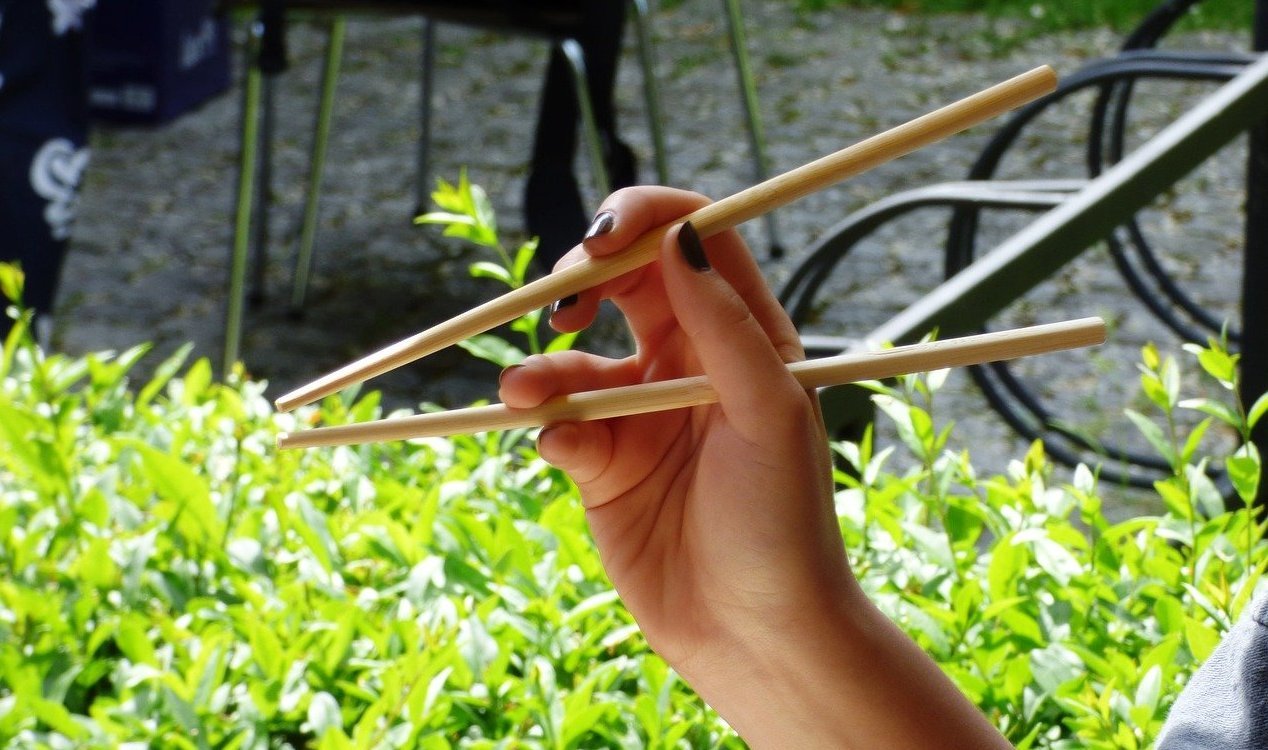 A woman holding chopsticks.