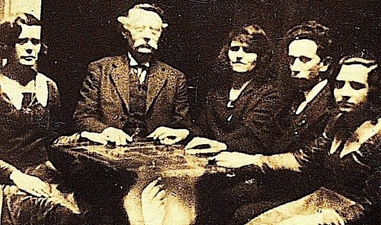 Five people taking part in a seance in 1920.