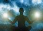 Silhouette of a person meditating with stars in the background.
